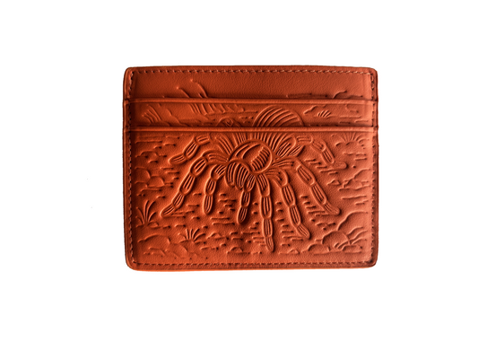 Front view of orange HAMORI cardholder with debossed tarantula